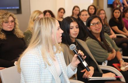 Women attending a panel discussion